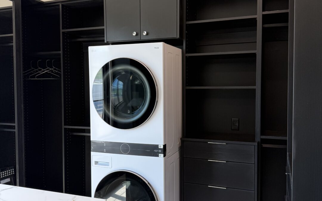 Walk in closet with safe and washer/dryer